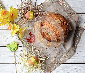 A traditional Easter cake and festive decoration on a white wooden surface