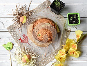 A traditional Easter cake and festive decoration on a white wooden surface