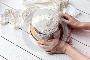 A traditional Easter cake and festive decoration on a white wooden surface