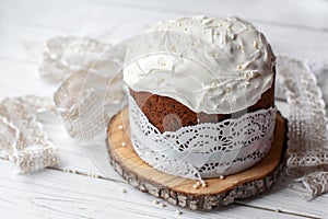 A traditional Easter cake and festive decoration on a white wooden surface