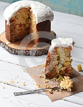 A traditional Easter cake and festive decoration on a white wooden surface