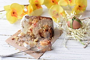 A traditional Easter cake and festive decoration on a white wooden surface