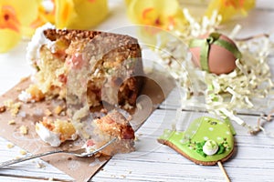 A traditional Easter cake and festive decoration on a white wooden surface