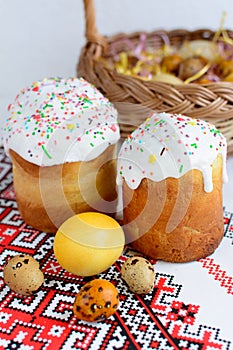 Traditional easter cake kulich Ukrainian style with colored eggs on painted towel