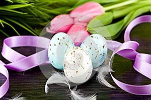 Traditional easter egg decoration with tulips and ribbo