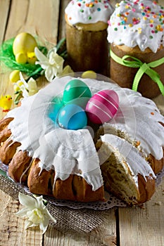 Traditional Easter food cake: the dough wrapped in a roll with nut filling and raisins, with sweet icing. Festive Easter table