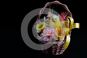 Traditional Easter Holiday basket with little chicken and flowers..