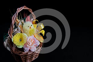 Traditional Easter Holiday basket with little chicken and flowers..