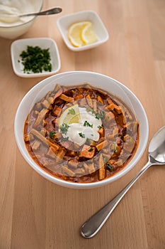 Traditional Eastern Germany GDR DDR Soljanka soup is a typical stew with pepper, meat, sausage, cream and lemon