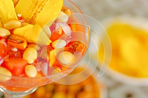 Traditional ecuadorian cold tomato based dish with chochos, onions and banana chips as seen from above, elegant