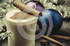 Traditional eggnog in a glass and christmas decoration/Traditional eggnog in a glass and christmas decoration. Selective focus