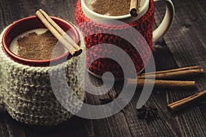 traditional eggnog in red and white mugs/traditional eggnog in red and white mugs on a wooden dark background