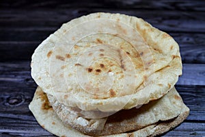 Traditional Egyptian flat bread with wheat bran and flour, regular Aish Baladi or Egypt bread baked in extremely hot ovens, it is