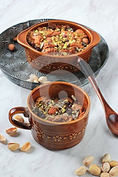 Traditional Egyptian Sweet Pastry Dessert Bread Pudding Om Ali or Umm Ali of Soaked Bread, Milk and Load of Roasted Nut