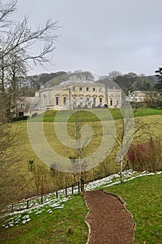 A traditional English 18th century manor house above a footpath in winter