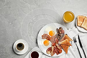 Traditional English breakfast served on grey marble table, flat lay. Space for text