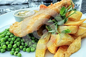 Traditional english food fish and chips with green peas