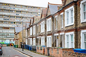 Traditional English terraced houses with council block Aylesbury Estate in the background