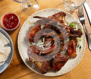 Traditional european dish Shashlik cordero - fried lamb kebab with onion on plate photo