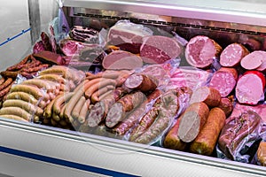 Traditional european sausages and meats in a shop window