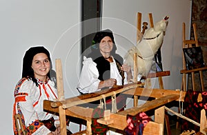 Traditional evening sitting with woman who spinning wool