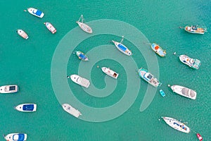 Traditional eyed colorful boats in the harbor of Mediterranean fishing village, aerial view Marsaxlokk, Malta