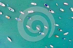 Traditional eyed colorful boats in the harbor of Mediterranean fishing village, aerial view Marsaxlokk, Malta