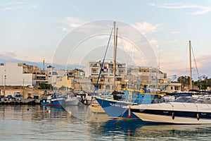 Traditional eyed colorful boats Luzzu in the Harbor of Mediterranean fishing village Marsaxlokk, Malta