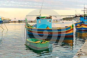 Traditional eyed colorful boats Luzzu in the Harbor of Mediterranean fishing village Marsaxlokk, Malta