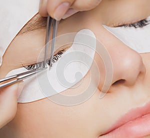 Traditional eyelash extensions. Selective focus. Toned. Makeup close-up.