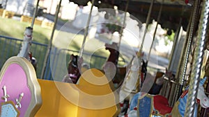 Traditional Fairground Vintage Carousel in Park. Merry-go-round with horses at funfair.