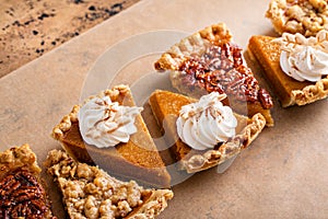 Traditional fall Thanksgiving pie slices, pumpkin and pecan pie