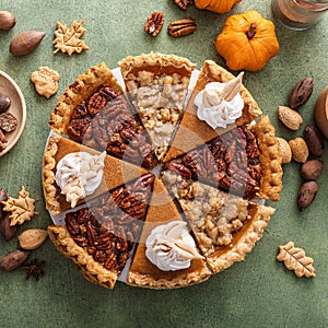 Traditional fall Thanksgiving pie slices, pumpkin and pecan pie