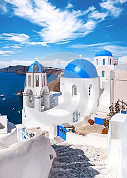 Traditional and famous houses and churches with blue domes over the Caldera, Oia, Santorini, Greece island, Aegean sea. Beautiful