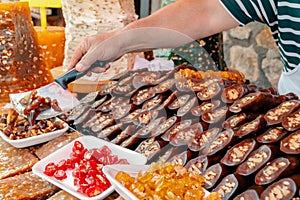 Traditional famous Turkish sweet Walnut Sausage and Paste with walnut on a showcase in a food s