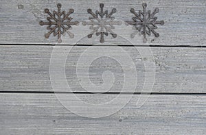 Three Rustic Snowflakes on Wood Texture Background Framed Copy Space