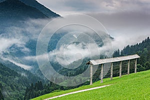 Traditional farming, hayrack in Slovenia mountains at misty day