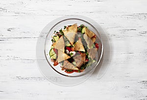 Traditional Fattoush salad  with vegetables and pita bread. Levantine, Arabic, Middle Eastern cuisine