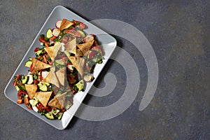 Traditional Fattoush salad  with vegetables and pita bread. Levantine, Arabic, Middle Eastern cuisine