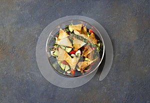 Traditional Fattoush salad  with vegetables and pita bread. Levantine, Arabic, Middle Eastern cuisine