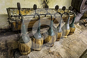 Traditional fiasco straw bottles at a vineyard, Chianti Classico, Tuscany Italy