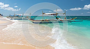 Traditional filipino asian ferry taxi tour boats on puka beach photo