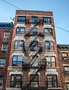 Traditional fire escape ladders at the facade of a New York`s apartment