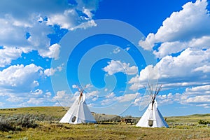 Native Teepees in a grassland photo