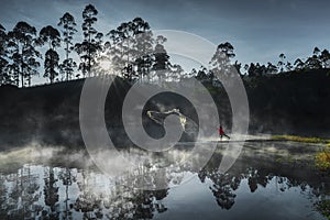 Traditional fishermen Catch fish in a lake full of fog