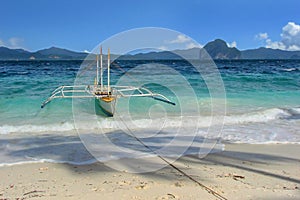 Traditional fishing boat on the beach at Entalula island in El Nido, Palawan Philippines