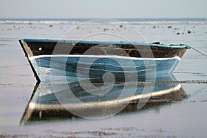 Traditional fishing boat with reflection on the water