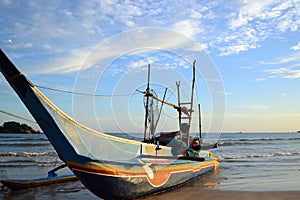 Traditional fishing boat of Sri Lankan fishermen moored on the beach of ocean