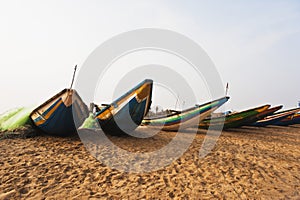 Traditional fishing boats on the beach, Puri, Orissa, India photo