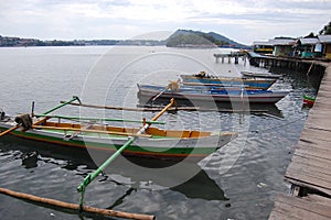 Traditional fishing boats at timber pier Indonesia